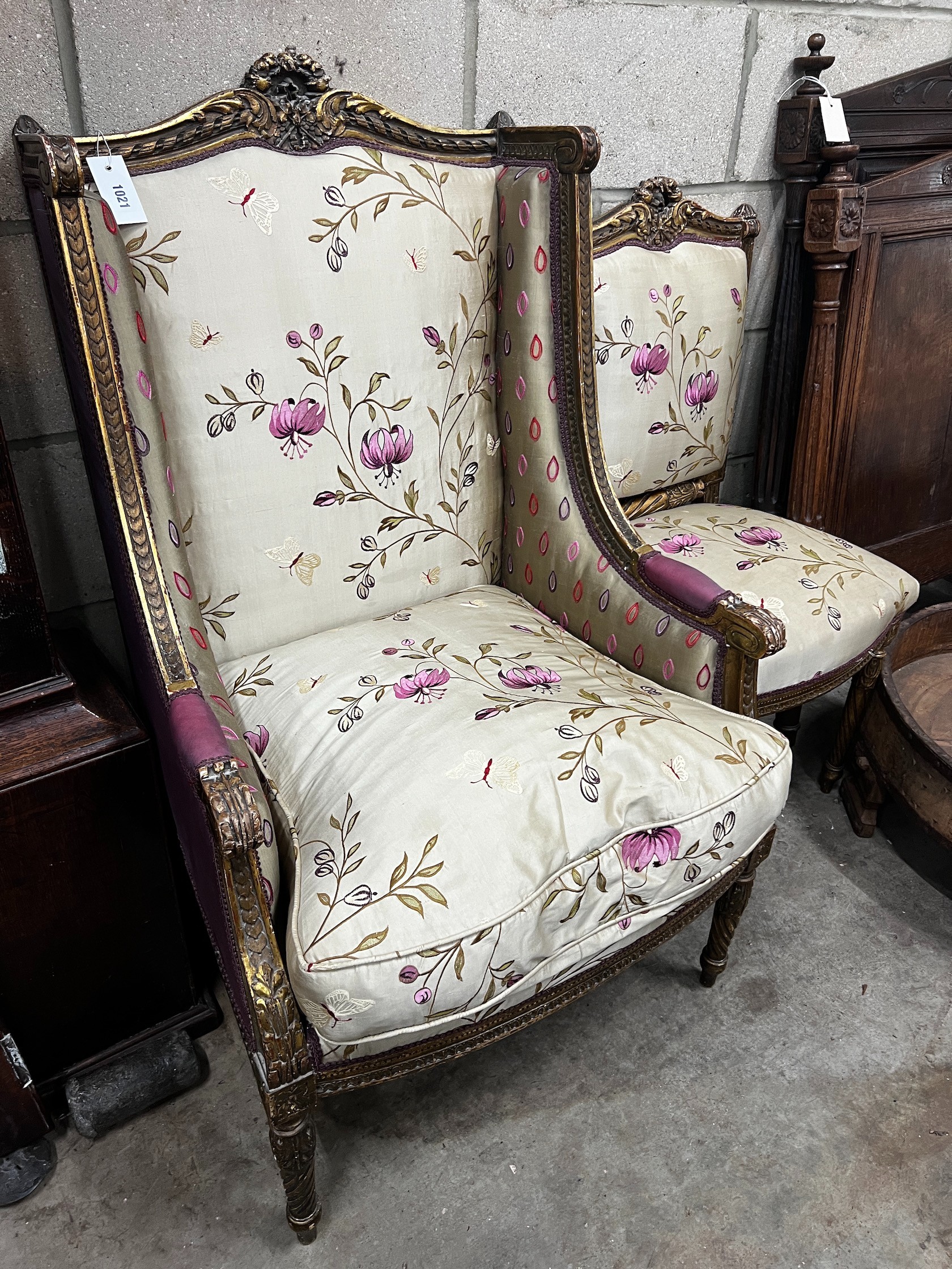 A late 19th century French carved giltwood and composition armchair, width 58cm depth 62cm height 104cm, with matching side chair